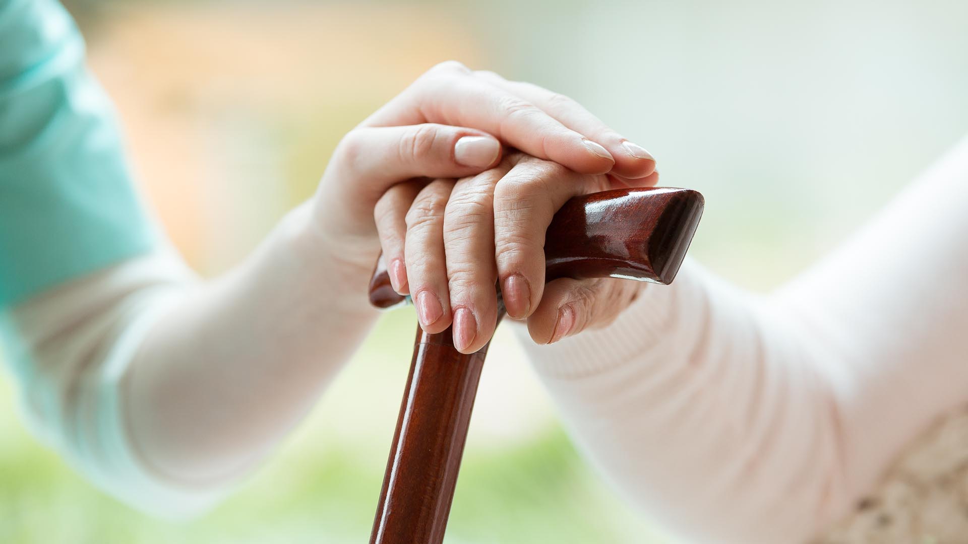 Close Up of Young Hand Tapping on Old Woman Hand
